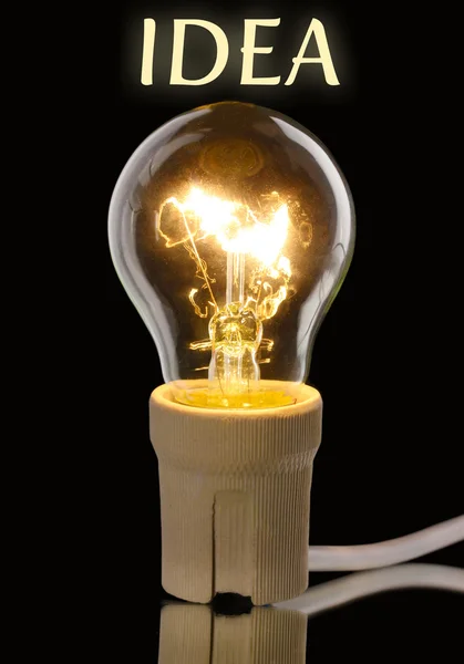 Light bulb on dark background — Stock Photo, Image