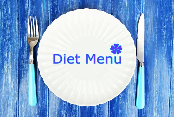 Plate with text "Diet Menu", fork and knife on color wooden background — Stock Photo, Image