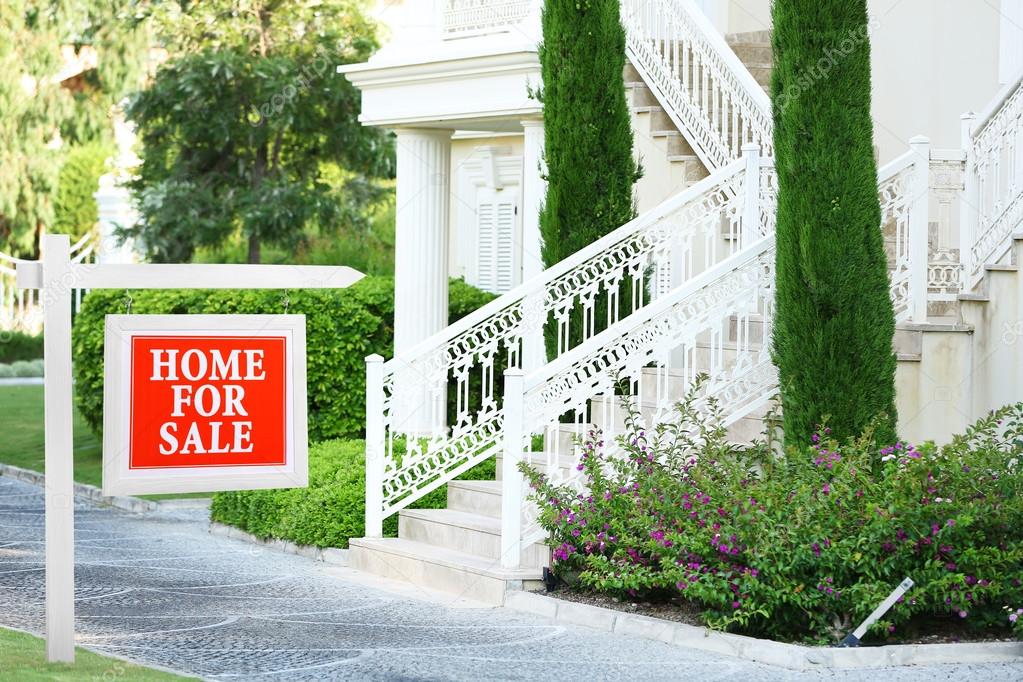 Home for sale Real estate sign in front of new house