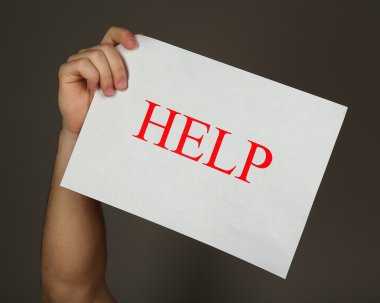 Kağıdın yardımıyla koyu arka plan üzerinde erkek elinde kayıt