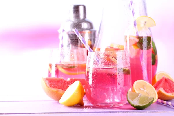 Рожевий лимонад в окулярах і глечик на столі крупним планом — стокове фото