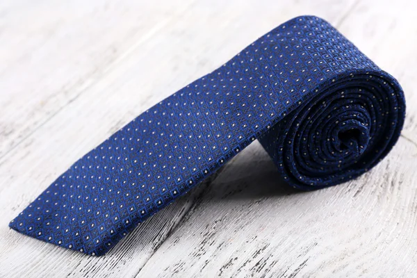 Trendy tie on color wooden background — Stock Photo, Image