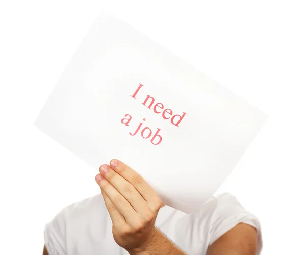 Foglio di carta con iscrizione Ho bisogno di un lavoro in mano maschile isolato su bianco — Foto Stock