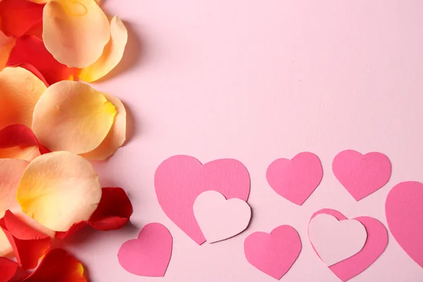 Beautiful hand made post card with hearts and rose petals, close-up — Stock Photo, Image