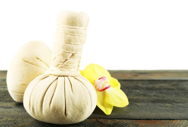 Herbal massage bags with orchid on table on light background — Stock Photo, Image