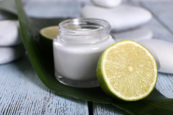 Cosmetic cream with half lime — Stock Photo, Image