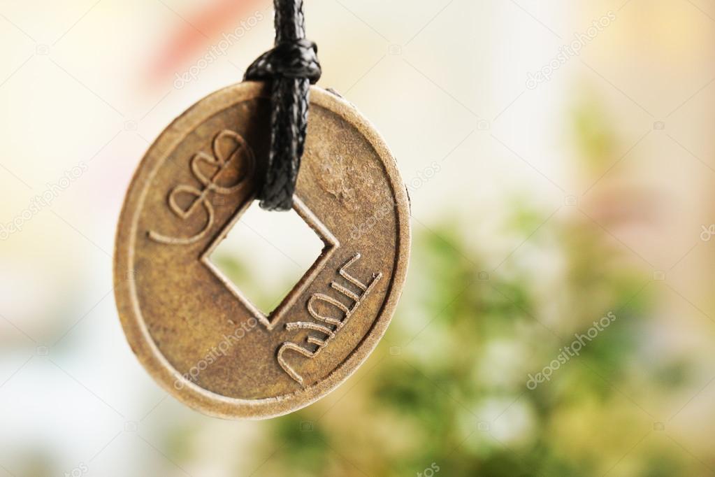 Feng shui coin on light background