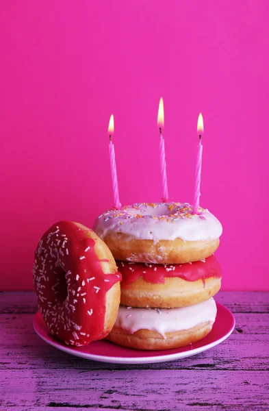 Delicious donuts with birthday candles — Stock Photo, Image