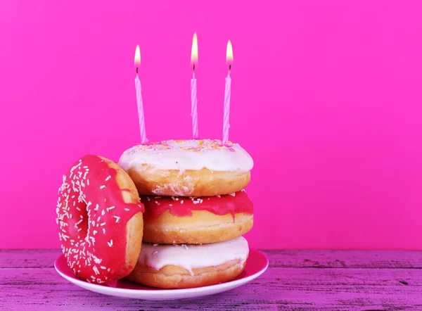Delicious donuts with birthday candles — Stock Photo, Image