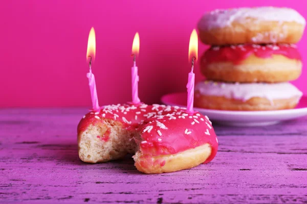 Delicious donuts with birthday candles — Stock Photo, Image