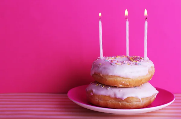 Delicious donuts with birthday candles — Stock Photo, Image