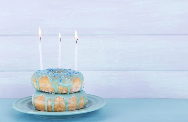 Delicious donuts with birthday candles — Stock Photo, Image