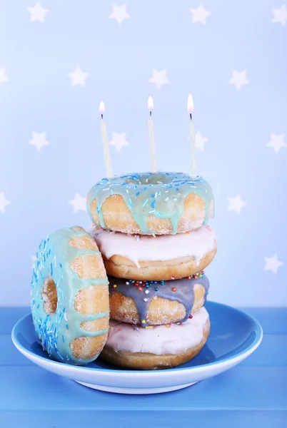 Delicious donuts with birthday candles — Stock Photo, Image