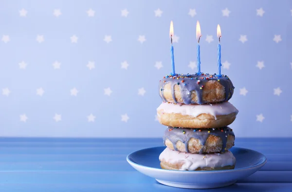 Delicious donuts with birthday candles — Stock Photo, Image