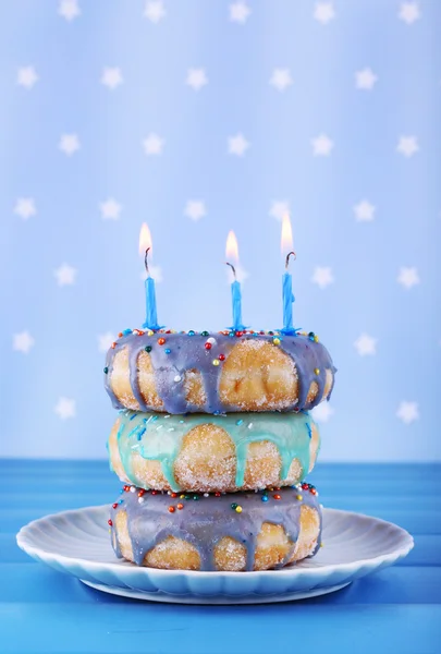 Delicious donuts with birthday candles — Stock Photo, Image