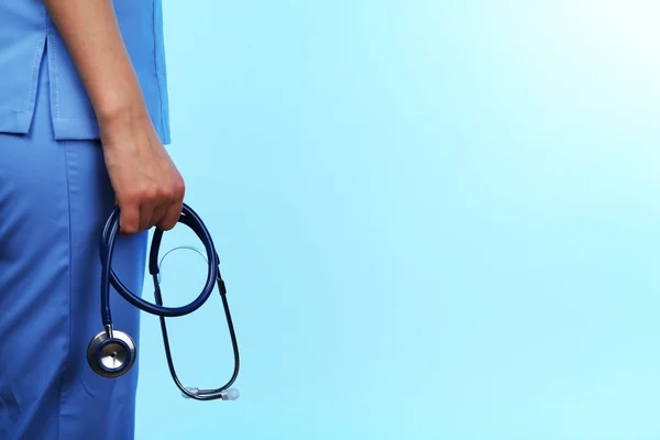 Doctor with stethoscope on blue background — Stock Photo, Image