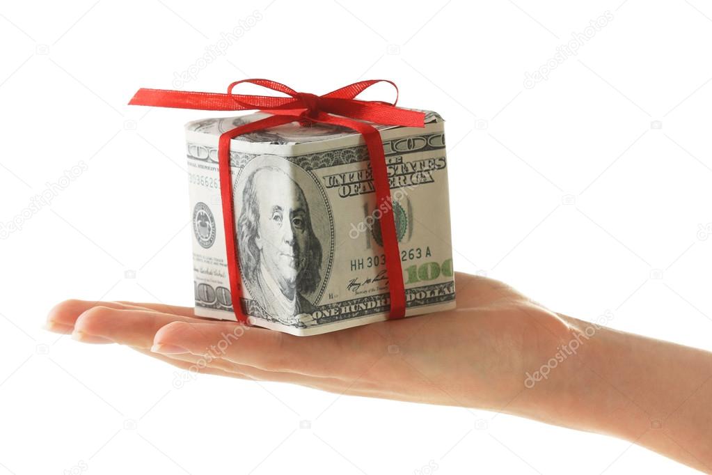 Hand holding dollar gift box with bow isolated on white