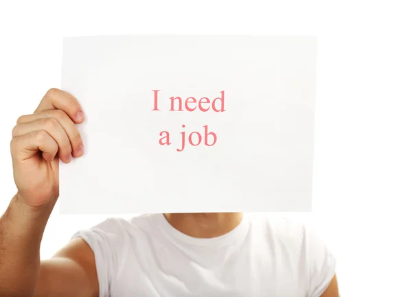 Arkusz papieru z napisem Potrzebuję pracy w męskiej ręce odizolowany na białym — Zdjęcie stockowe