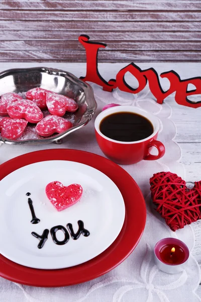 Cookie in form of heart on plate with inscription I Love You on color wooden table background — Stock Photo, Image