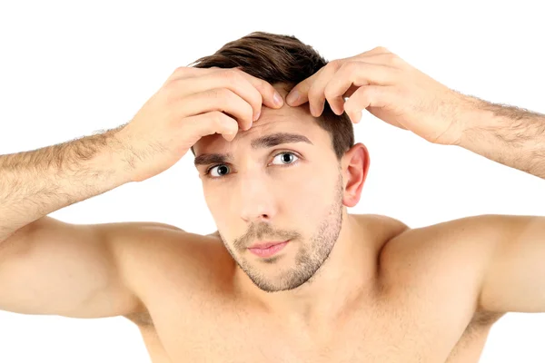 Young man squeezing pimple — Stock Photo, Image