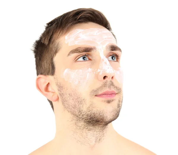 Hombre joven guapo con loción de crema en la cara aislado en blanco — Foto de Stock