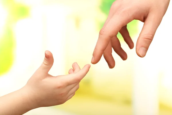 Çocuk ve babası eller üzerinde parlak arka plan — Stok fotoğraf