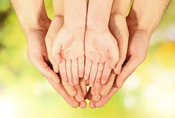 Family hands on bright background — Stock Photo, Image