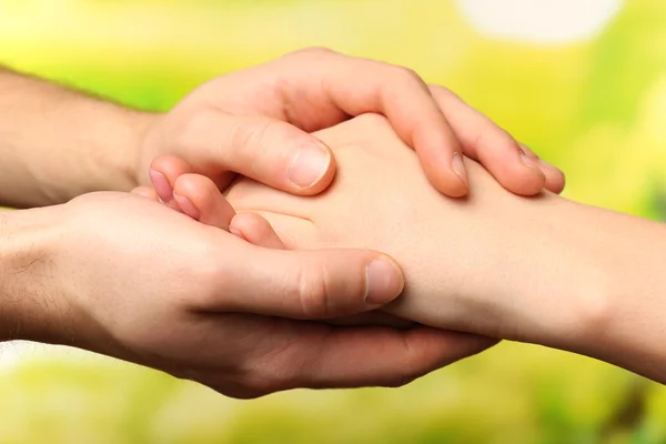 Male and female hands on bright background — Stock Photo, Image