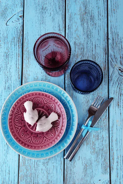 Lege kleurrijke borden, glazen en zilverwerk op houten tafel — Stockfoto