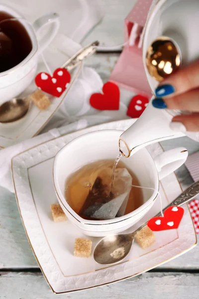 Woman pouring hot tea — Stock Photo, Image