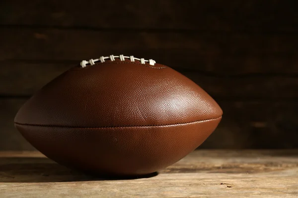 American football on wooden table, close up — Stock Photo, Image