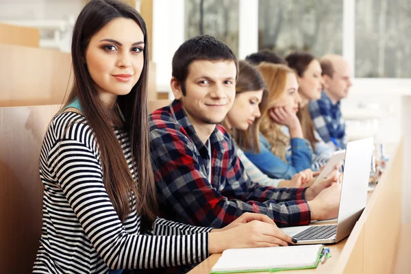 Grupo de estudiantes que utilizan aparatos en el aula — Foto de Stock