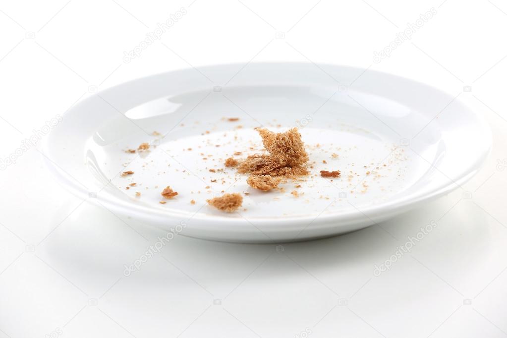 Bread crumbs on plate isolated on white