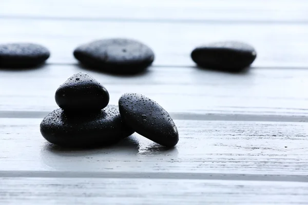 Piedras de spa con gotas de agua sobre fondo de madera —  Fotos de Stock