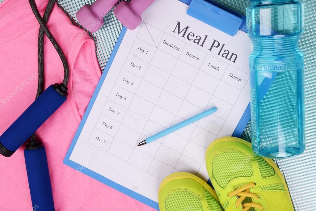 Meal plan and sports equipment top view close-up 