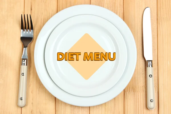 Plate with text Diet Menu, fork and knife on wooden background — Stock Photo, Image