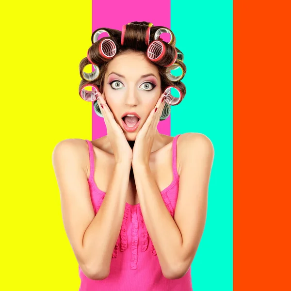 Beautiful girl in hair curlers on colorful background — Stock Photo, Image