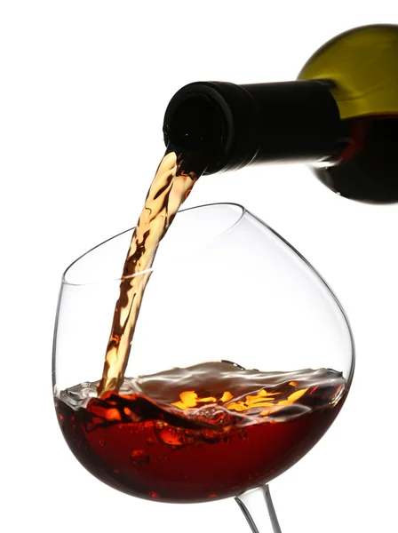 Red wine pouring into wine glass, isolated on white — Stock Photo, Image