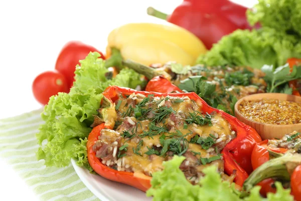 Stuffed red peppers on plate on napkin close up — Stock Photo, Image