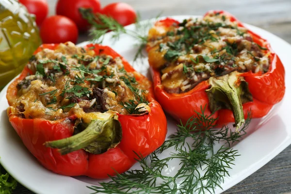 Stuffed red peppers with greens and vegetables on table close up — Stock Image Stuffed red peppers with greens and vegetables on table close up Stock Image