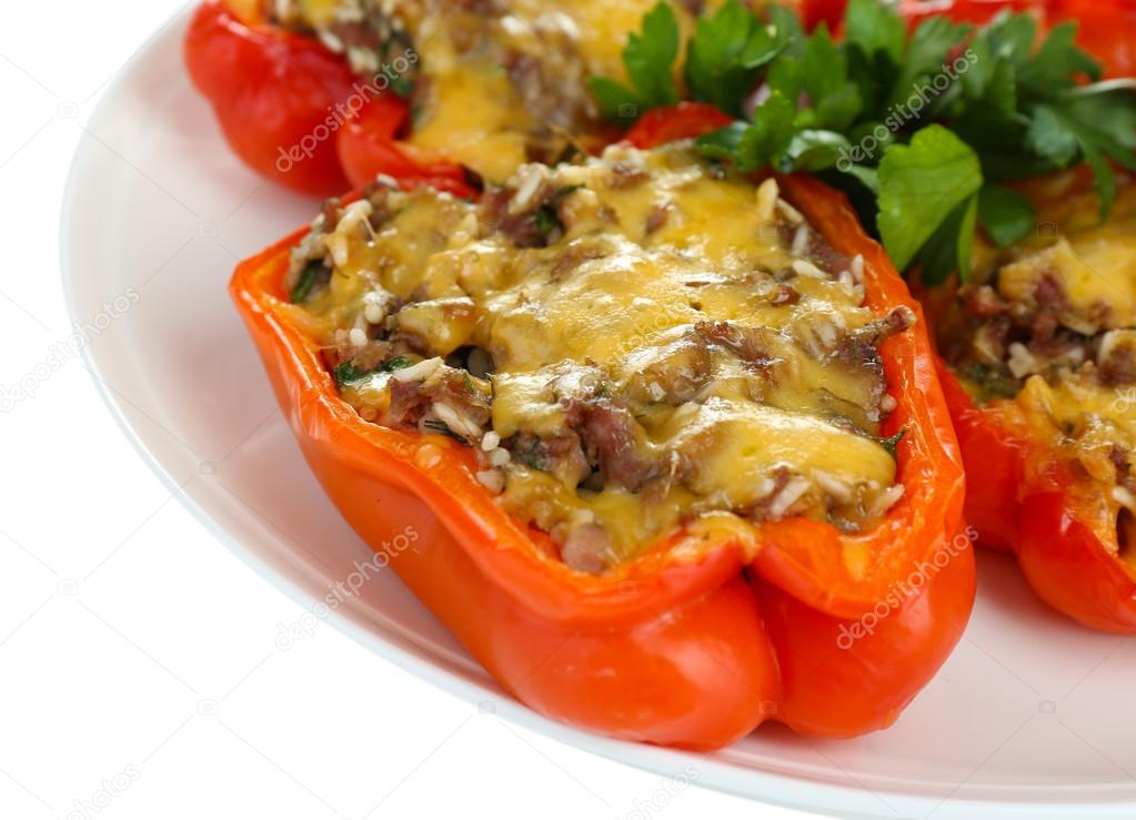 Stuffed red peppers on plate close up