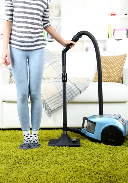 Girl vacuuming in room — Stock Photo, Image