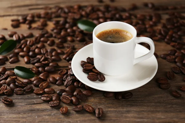 Cup of coffee on wooden table — Stock Photo, Image