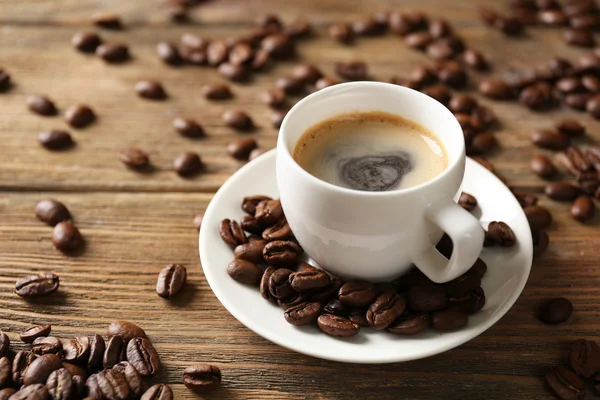 Cup of coffee on wooden table — Stock Photo, Image