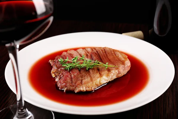 grilled steak in wine sauce