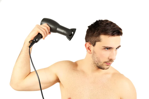 Handsome young man blow drying his hair isolated on white — Stock Photo, Image