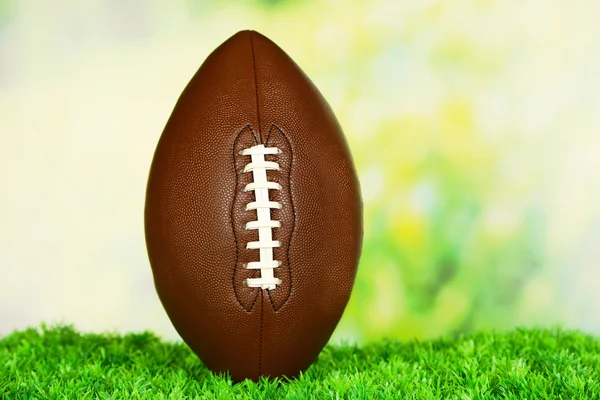 American football on field on green grass, on nature background — Stock Photo, Image