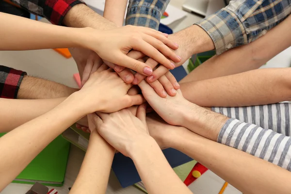 Mani unite del team aziendale sullo sfondo dell'area di lavoro vista dall'alto — Foto Stock