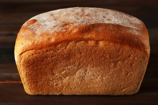 Fresh bread on wooden background — Stock Photo, Image