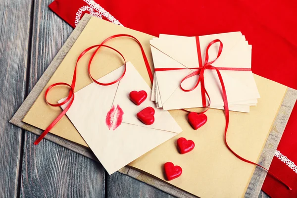 Love letters with red ribbon on wooden background — Stock Photo, Image